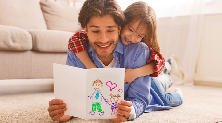 Dad looks at daughter's card