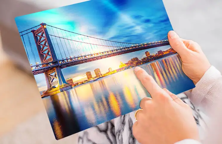 A lifestyle shot of a metal print with a bridge on it